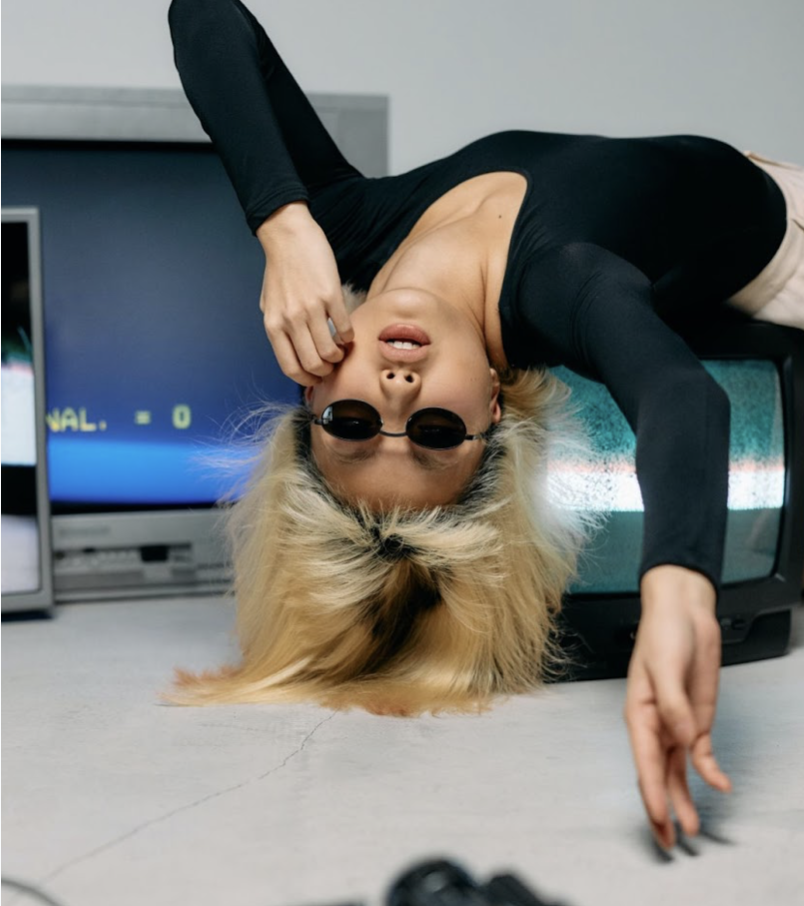 Model poses upside down on television