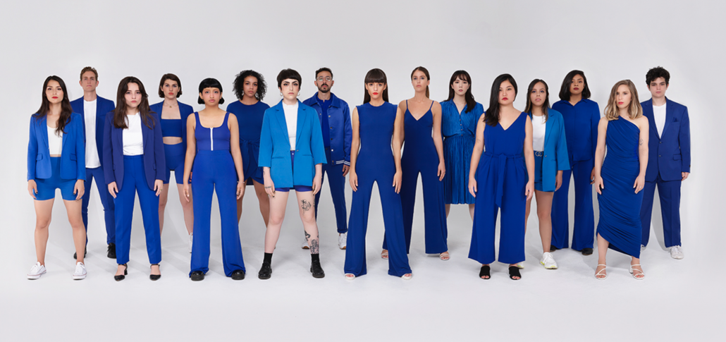 Fashion employees stand with their leader in blue