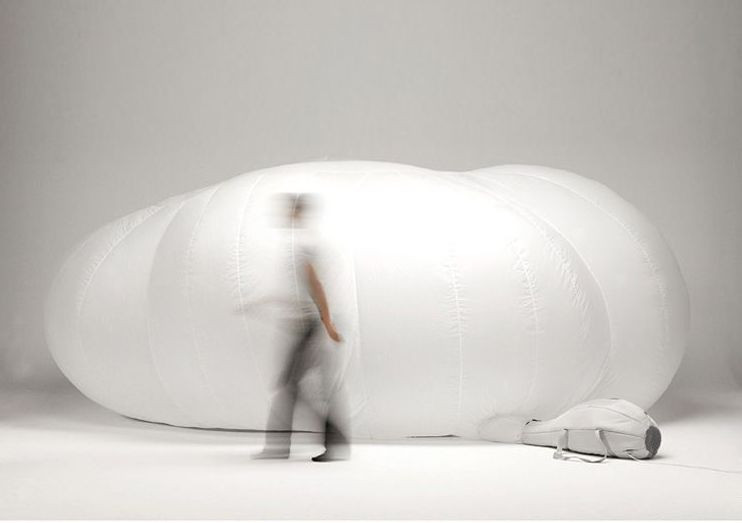 Model walks blearily across an inflatable cloud for t